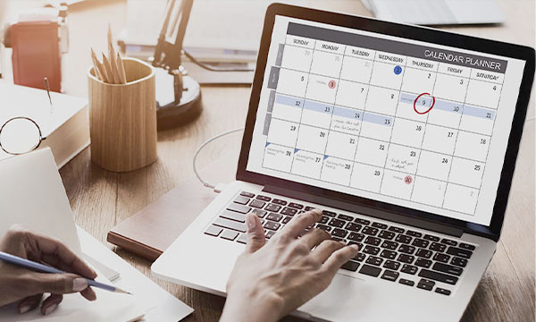 Woman reviewing calendar on laptop